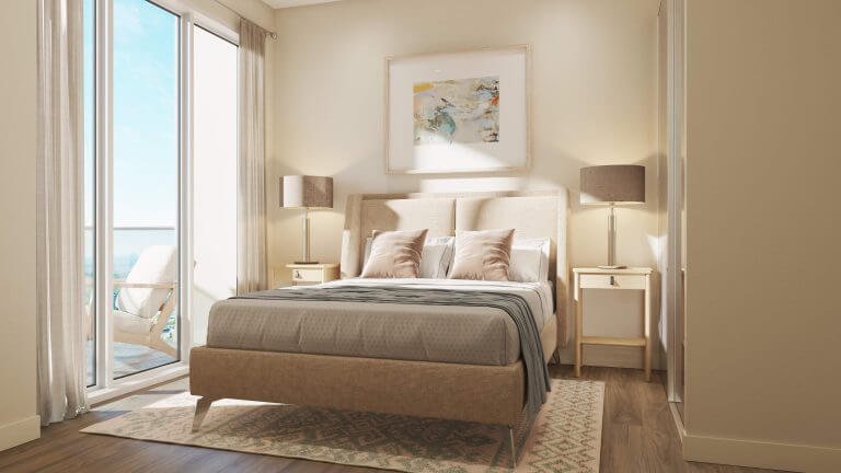 A cozy bedroom in one of the new condos features a beige bed, gray blanket, and two pillows. A large window with sheer curtains lets in natural light. Two matching lamps sit on bedside tables, and a painting hangs above the bed. A balcony with chairs is visible outside—Gagan Bector living at its finest.