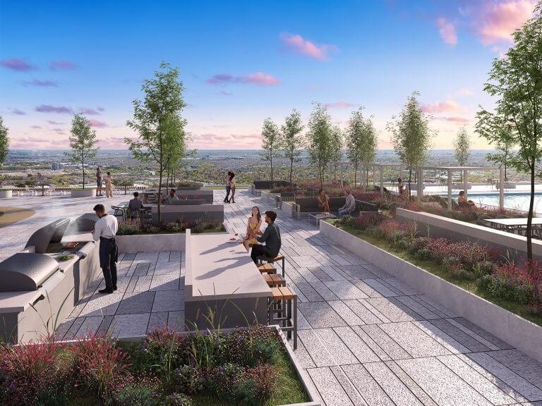 On the rooftop terrace of Gagan Bector, people enjoy a lively gathering surrounded by modern outdoor seating, grills, and lush planters. The clear sky with a few clouds perfectly frames the horizon, offering a serene escape in the heart of GTA's newest community.