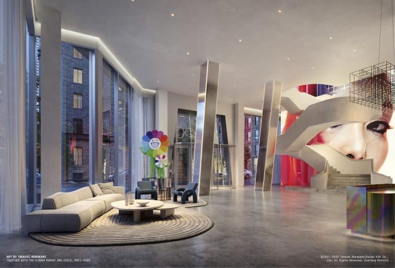 A modern, spacious lobby with large floor-to-ceiling windows at Freed Residences. It features contemporary furniture, including a curved sofa and round tables. Artistic elements include a colorful flower sculpture and a large mural of a woman's face on the wall alongside a staircase.