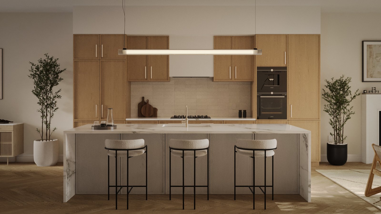 The modern kitchen in new homes in GTA features light wood cabinets, a marble island with three cushioned bar stools, a sleek hanging light fixture, two potted plants, and built-in stainless steel appliances. The room is warmly lit and elegantly organized.