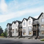 A row of modern, three-story townhouses designed by Gagan Bector stands with gabled roofs and large windows. The buildings, painted in neutral colors, overlook a mostly empty parking lot with a few cars. Under the clear blue sky, these pre-construction homes exude contemporary charm.