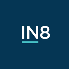 A minimalist logo design featuring the word "IN8 Developments" in white capital letters on a navy blue background, with a horizontal line beneath the letter "n".