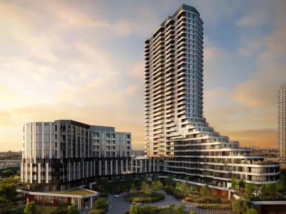 The Clove, a modern high-rise residential building with a unique, flowing design, stands majestically against a sunset sky. Surrounding the main tower are smaller buildings and lush greenery. The architecture features a mix of glass and concrete, emphasizing contemporary design.