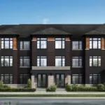 Modern three-story townhouse complex at Caledon Club with dark brick exterior, large windows, and landscaped greenery in front, set against a clear blue sky.