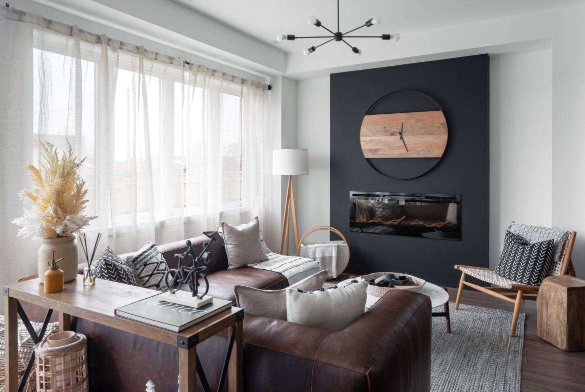 Bright sunlit family living room with large picture windows and hardwood flooring at Empire Calderwood