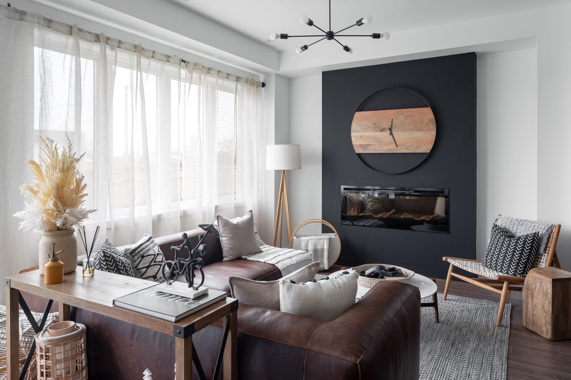 Bright sunlit family living room with large picture windows and hardwood flooring at Empire Calderwood