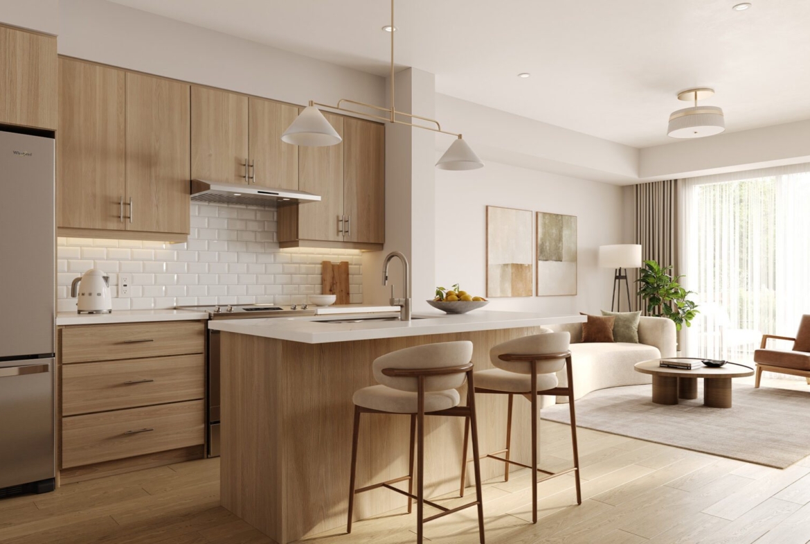 Bright open-concept gourmet kitchen and living room with designer finishes at Empire Wellwood