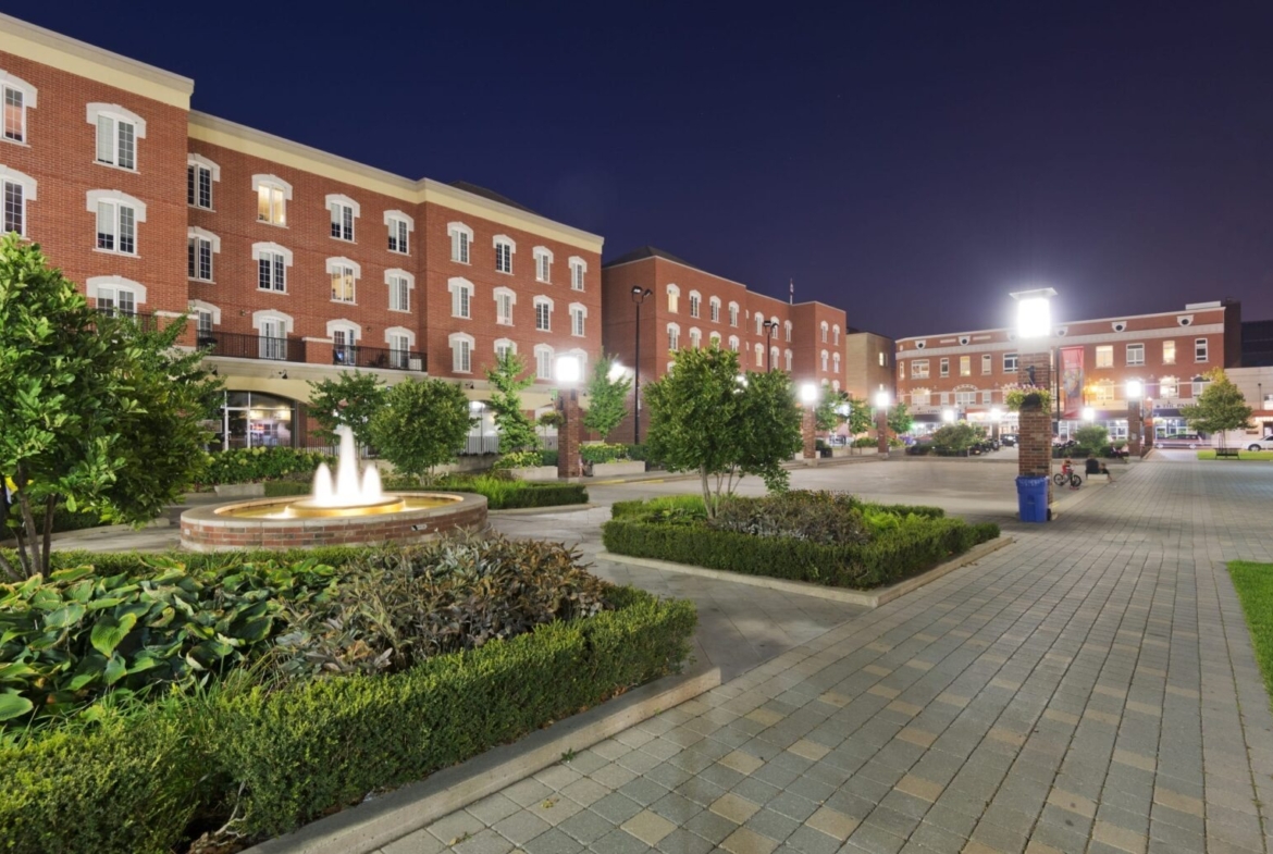 Completed single-family homes with mature trees and sidewalks at Empire Wyndfield