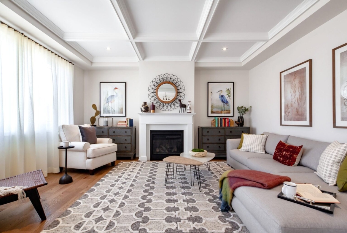 Spacious open-concept living room with large windows and hardwood flooring at Empire Wyndfield