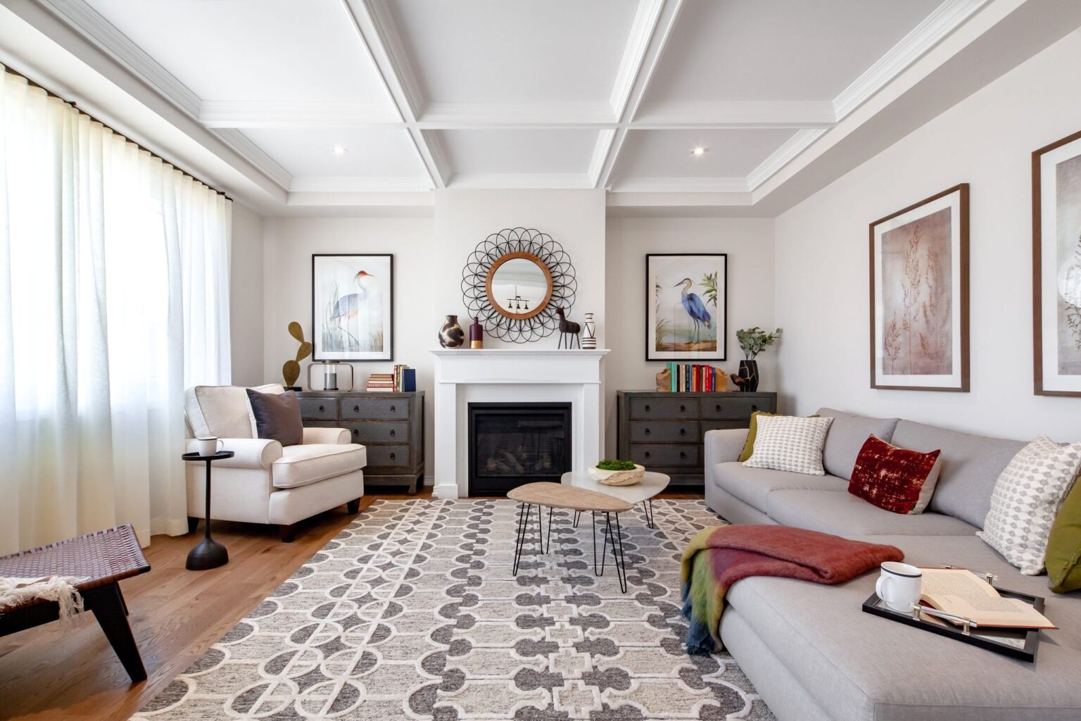 Spacious open-concept living room with large windows and hardwood flooring at Empire Wyndfield