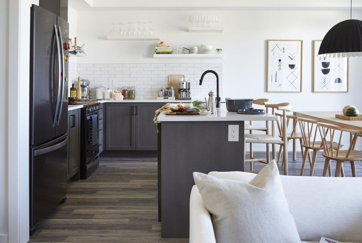 Open-concept designer kitchen with quartz countertops and custom cabinetry at Empire Wyndfield