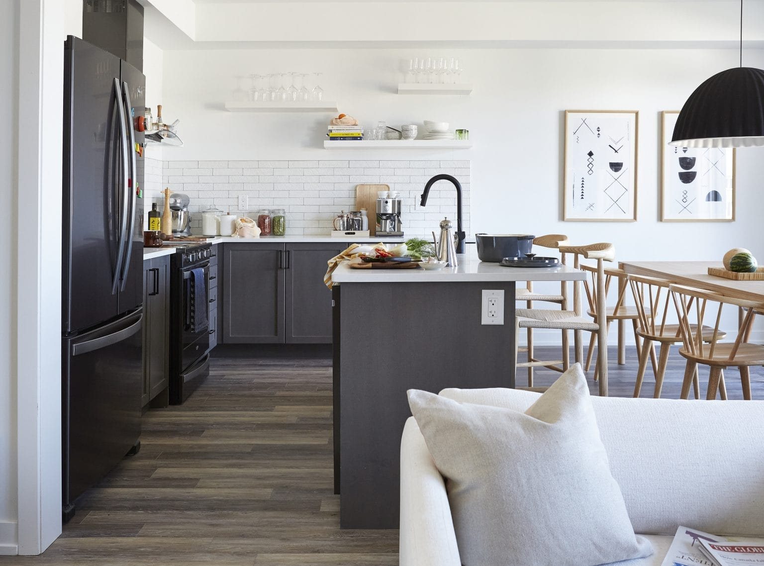 Open-concept designer kitchen with quartz countertops and custom cabinetry at Empire Wyndfield