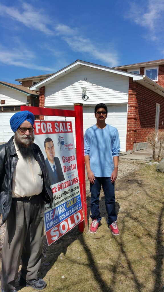 Two men standing in front of a house.
